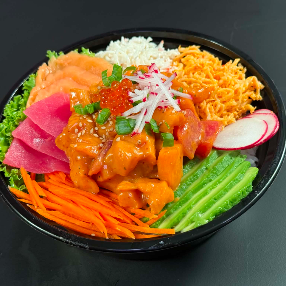 Colorful poke bowl with salmon, tuna, avocado, carrots, and rice on a dark background.